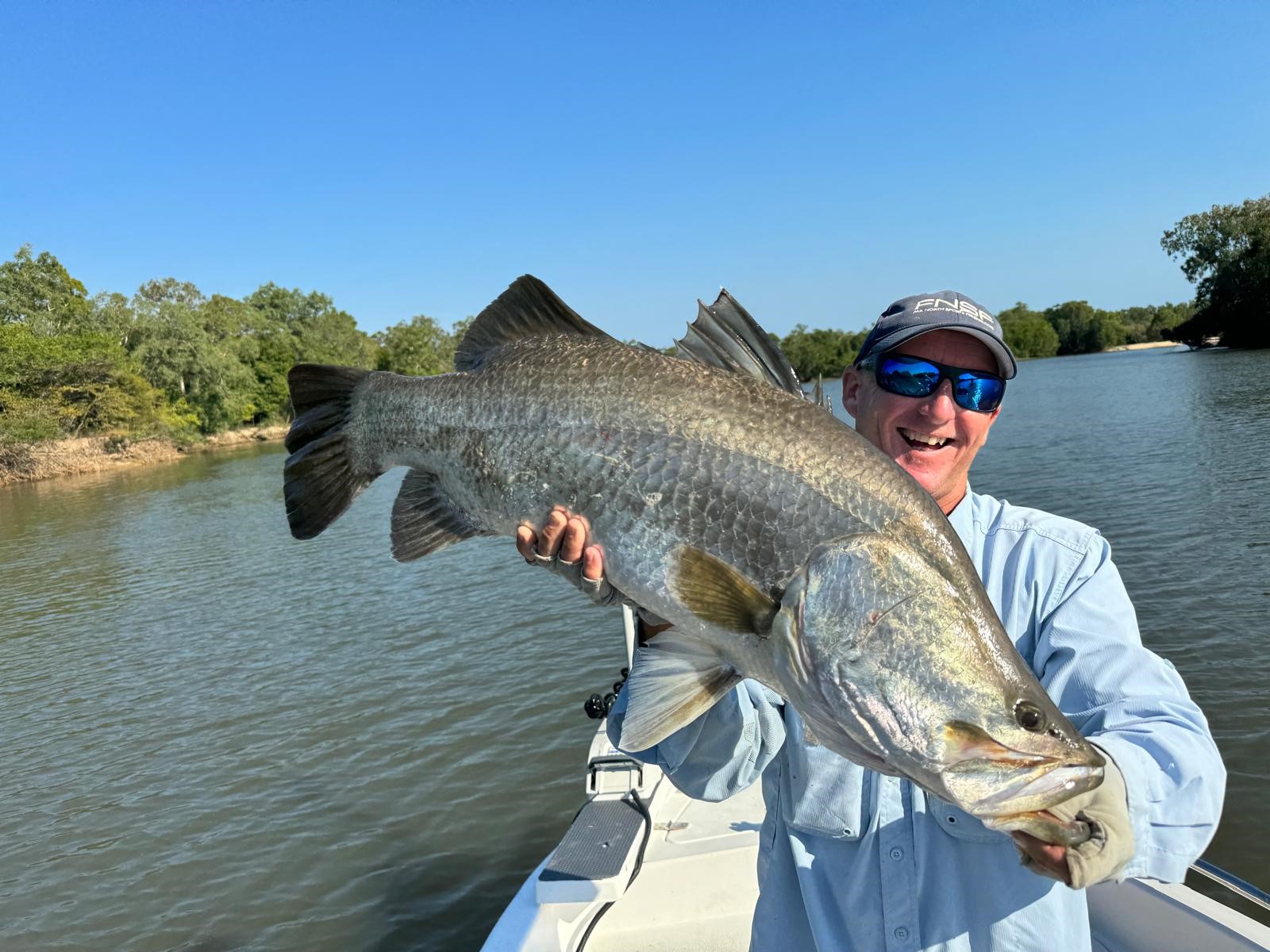 Fishing guide with huge Barramundi caught at remote Archer River